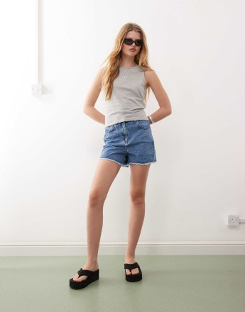 Reclaimed Vintage denim high waisted mom shorts with raw hem in mid blue wash