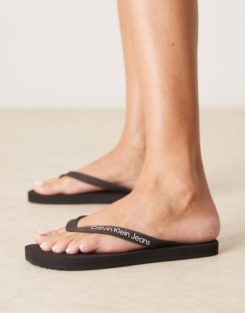 Calvin Klein Jeans logo flip flops in black
